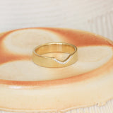 Lifestyle angled shot of Horizon Band Triangle Cutout Pave Round Diamonds in 14k yellow gold
