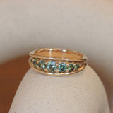 Lifestyle angled view of Humboldt Ring Round Sapphire 0.205ct by Goldpoint Jewelry on a ceramic with a blurred background