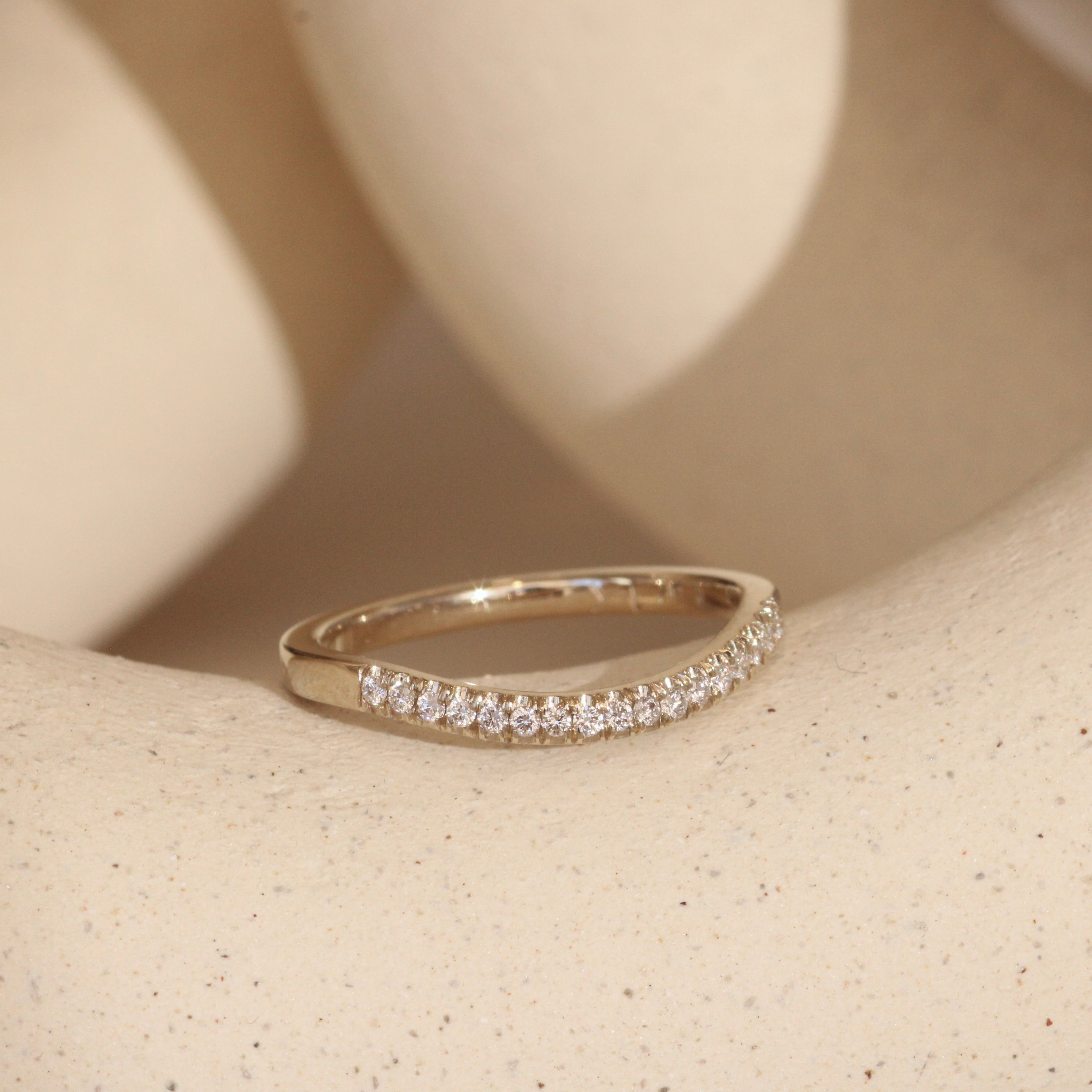 Lifestyle angled view of Flat Band Soft Curve Pave Round Diamonds in 14k white gold