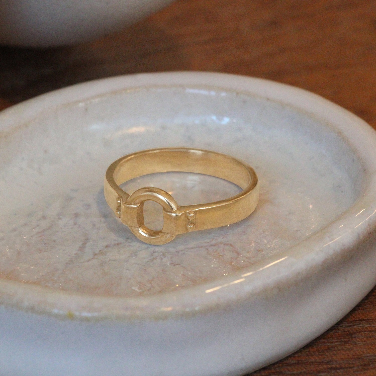 Lifestyle angled side view of Iris Ring by Amour Vee on a ceramic