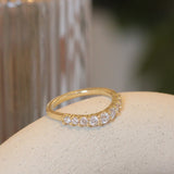 Lifestyle angled view of Keystone Band Soft Curve / Bead Round Lab Diamonds in 14k yellow gold by Goldpoint Jewelry on a ceramic