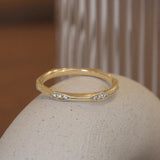 Lifestyle angled view of Kinship Band / Pave Round Natural Diamonds by Sandy Rubin on a ceramic with a blurred background