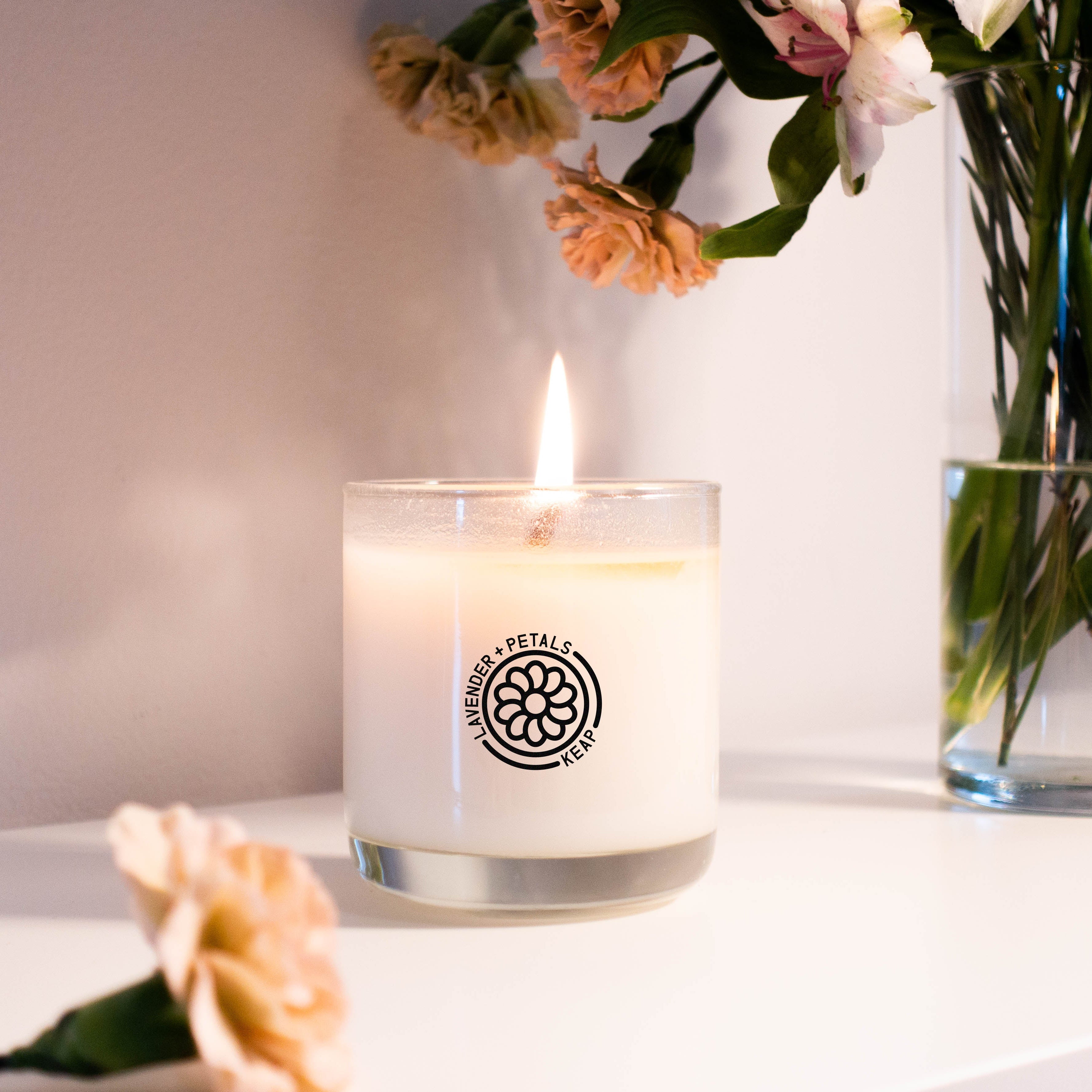 Lifestyle view of Lavender + Petals Scented Candle by Keap Candles on a shelf with flowers