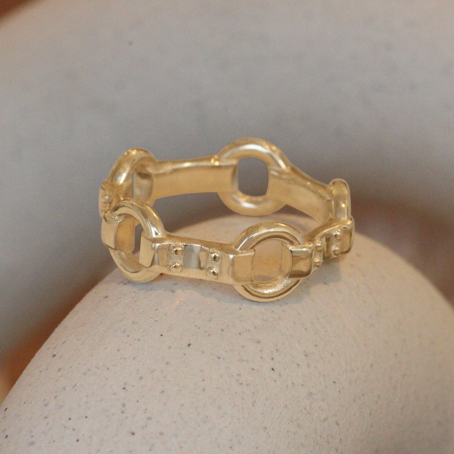 Lifestyle angled view of Lenny Ring by Amour Vee on a ceramic with a blurred background