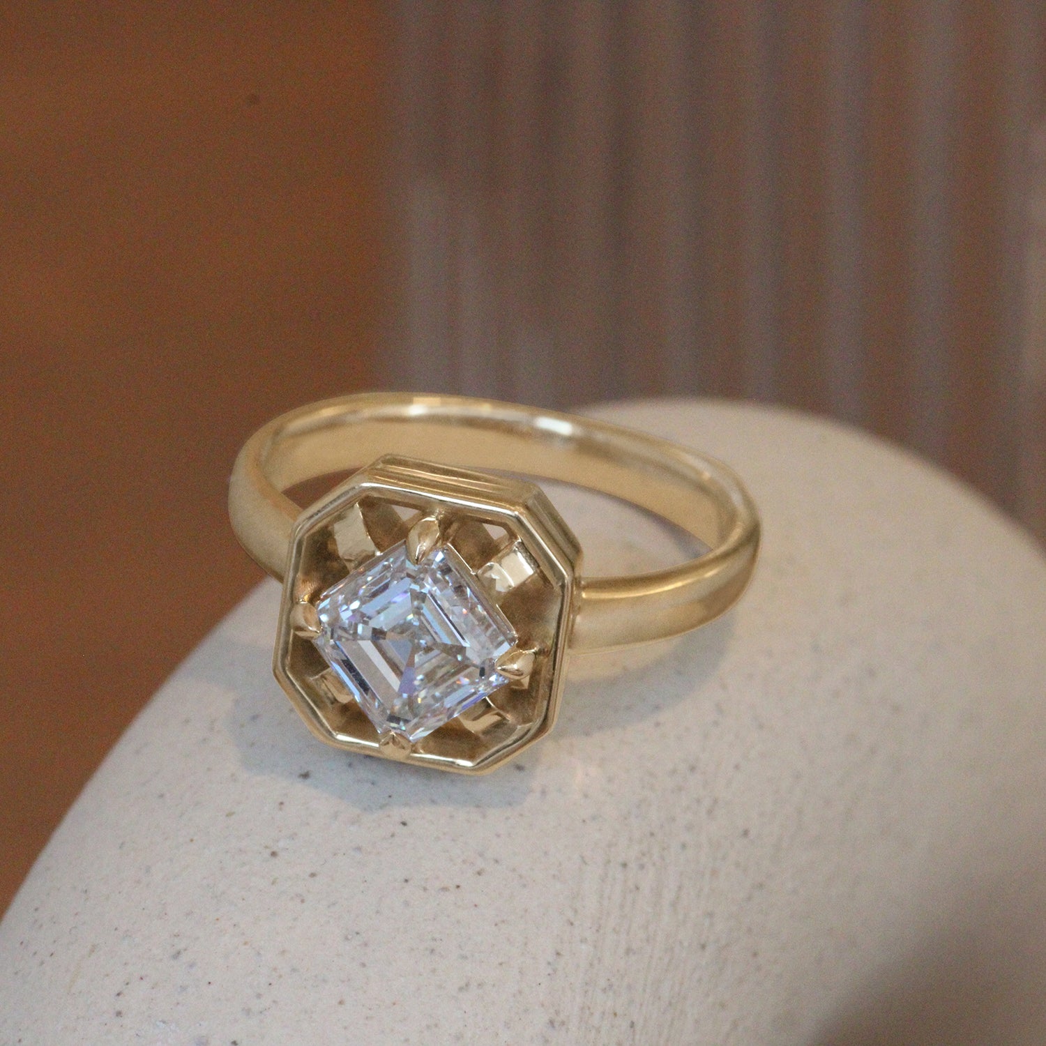 Lifestyle angled view of Midheaven Asscher Cut Lab Diamond Ring / Asscher Cut Lab Diamond 1.5ct by 12th House on a ceramic with blurred background