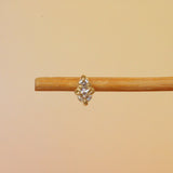 Lifestyle front view of Points Earring / Lab Diamond by Goldpoint Jewelry on a wooden earring display