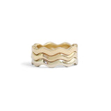 Stacked view of Waves Band in 14k White Gold, Waves Band in 14k Yellow Gold, and Waves Band in 18k Yellow Gold