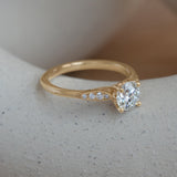 Lifestyle angled side view of Entranced Ring / Round Lab Diamond 0.72ct by Sandy Rubin on a ceramic with a blurred neutral background