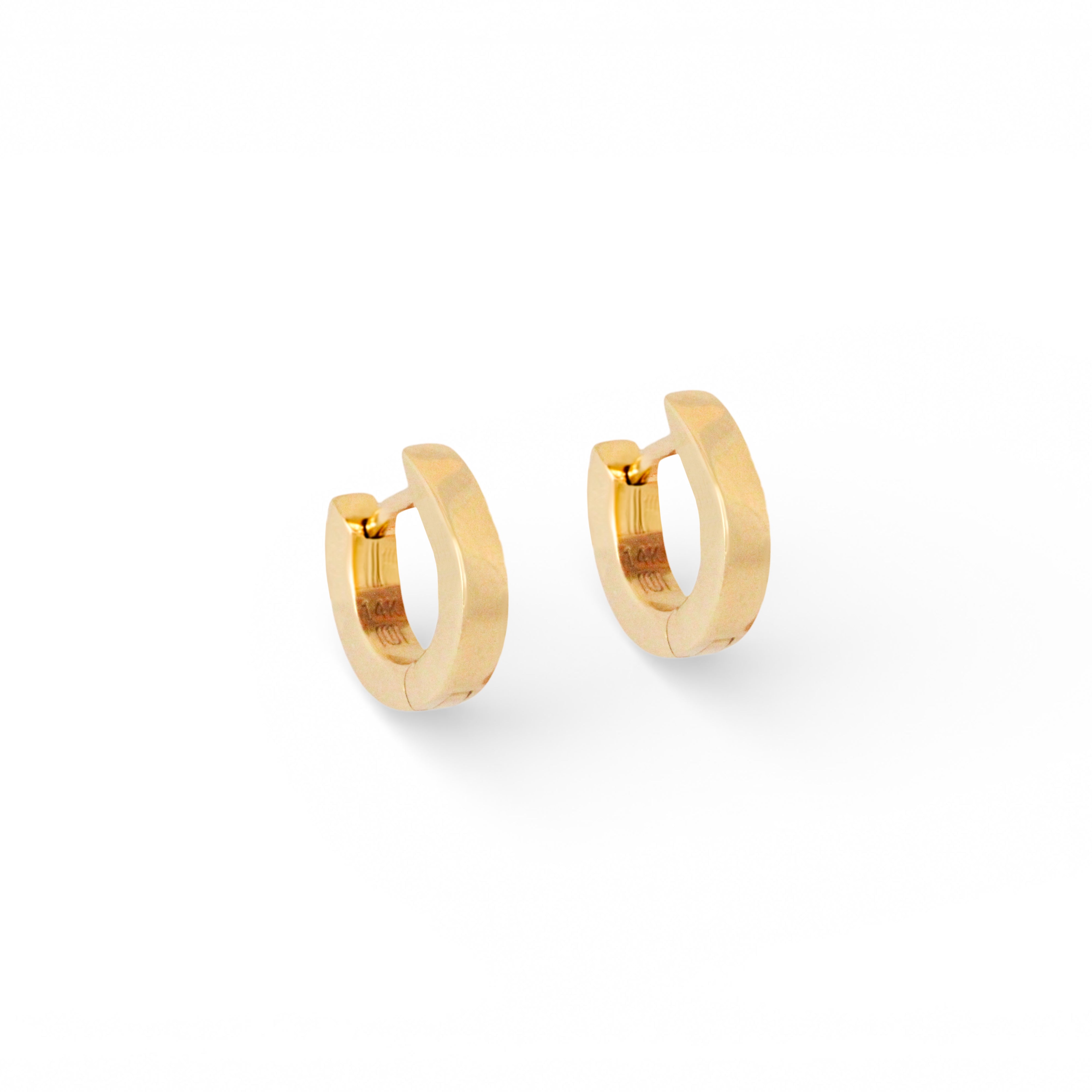Angled side view of Solid Huggie Hoops by Mon Pilar