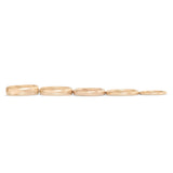 Lined up view of our Thick Dome Bands in various widths in 14k yellow gold