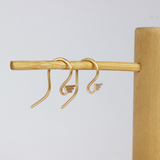 Lifestyle angled view of a set of Step S Hook Earring pieces by Goldpoint Jewelry