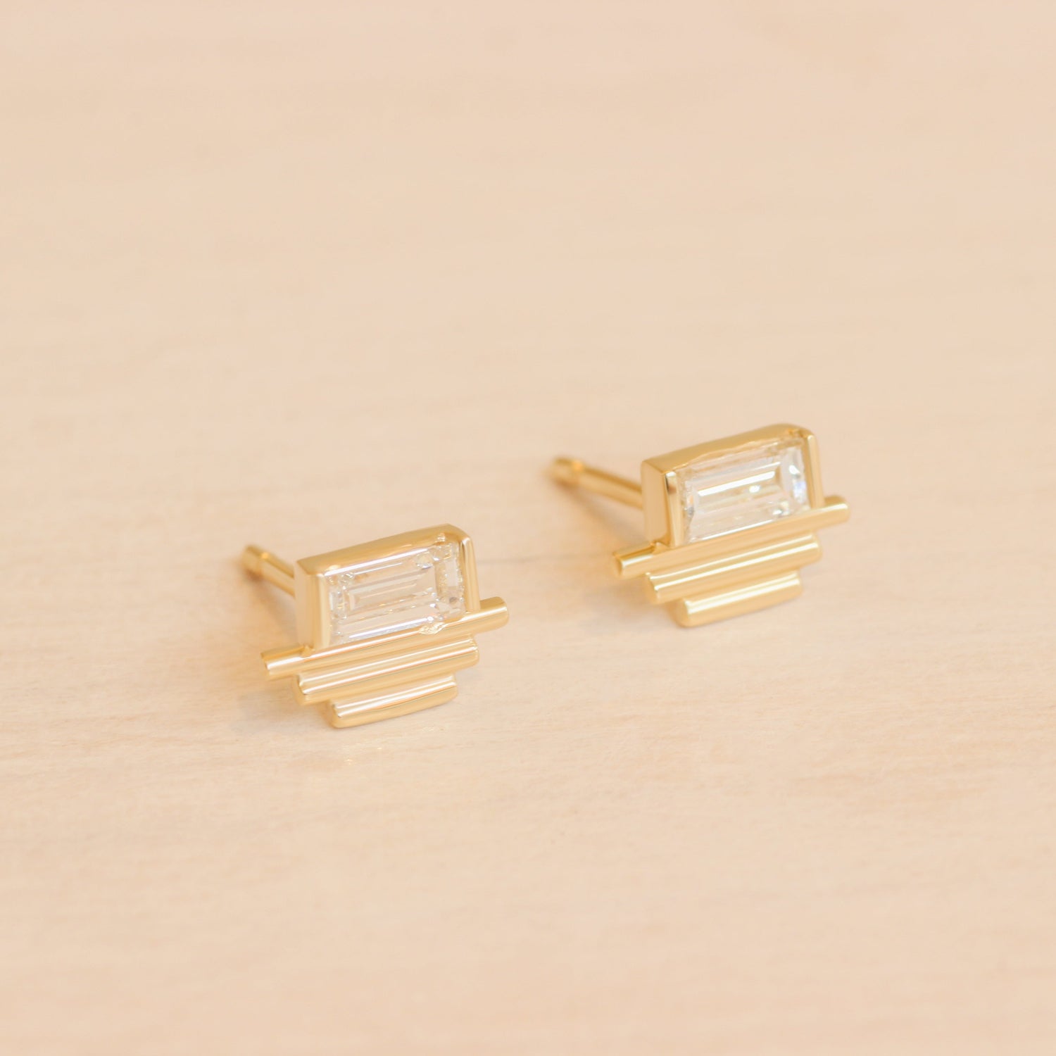 Lifestyle angled view of a set of Step Pyramid Earring / Lab Baguette Diamond pieces by Goldpoint Jewelry