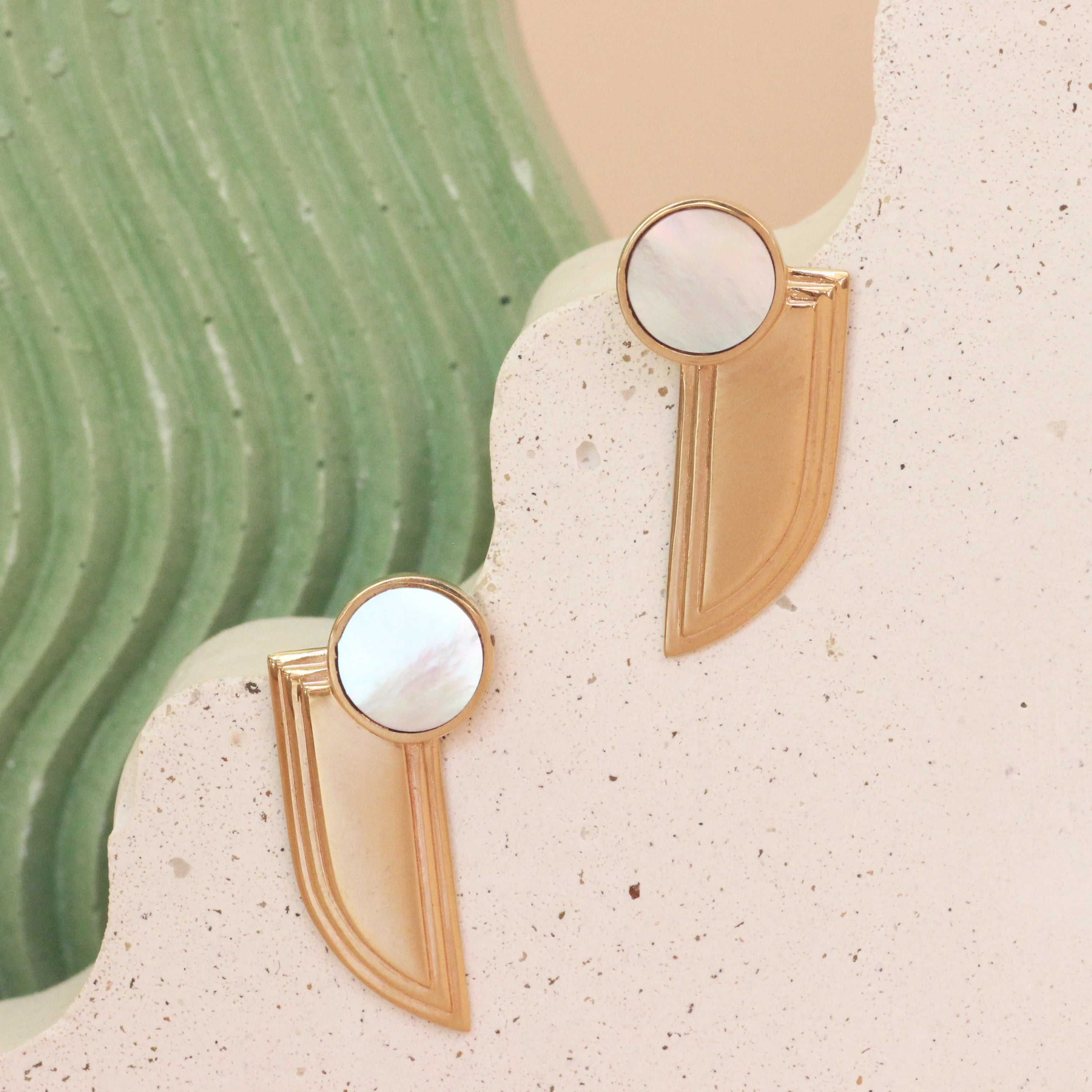 Lifestyle frontof Step Wing Earrings / Round Mother of Pearl Inlay by Goldpoint Jewelry on ceramics