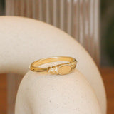 Lifestyle angled view of Step Signet Ring / Hexagon by Goldpoint Jewelry on a ceramic with a blurred background