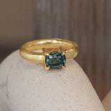 Lifestyle angled view of Sutton Ring Cushion Cut Sapphire 2.03ct by Goldpoint Jewelry on a ceramic with blurred background