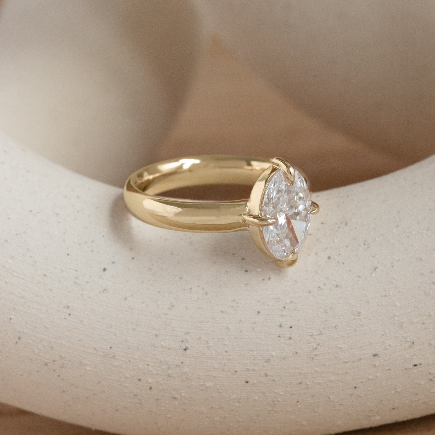 Lifestyle ide view of Sutton Ring / Oval Lab Diamond 2.04ct by Goldpoint Jewelry on a ceramic with a taupe background