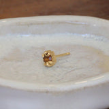 Lifestyle angled view of Talon Earring Round Citrine 4mm by Goldpoint Jewelry on a ceramic