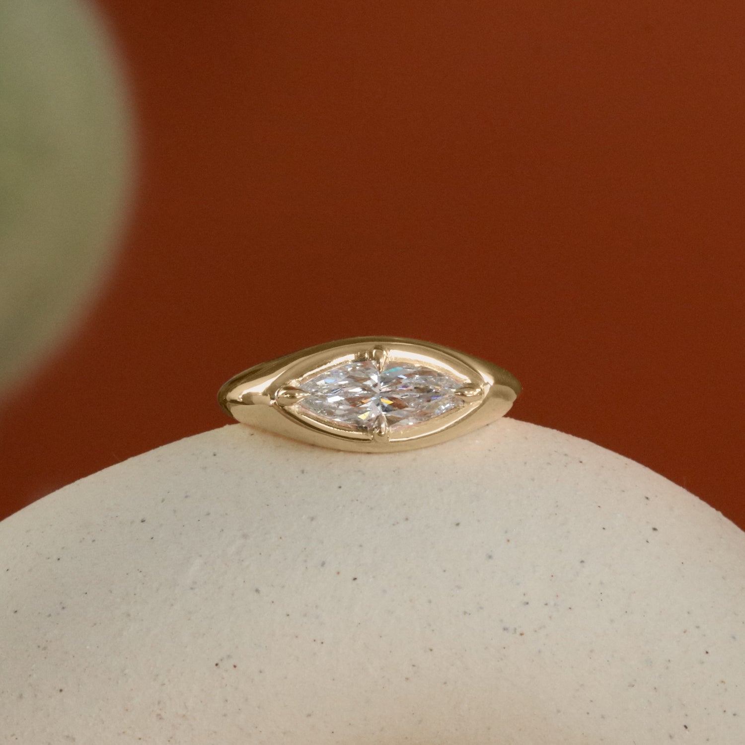 Lifestyle front view of Leonard 4 Ring Marquise Diamond 1.02ct by Goldpoint Jewelry on a ceramic with a orange background