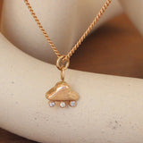 Lifestyle close view of UFO Lights Charm /  Round Natural Diamonds by Oxbow Designs hanging over a ceramic with a blurred background