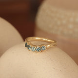 Lifestyle angled view of Cloud 5 Band Curve  Round Sapphires in 18k yellow gold