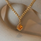 Lifestyle close view of Horus Orange Garnet Necklace / Wide Curb Chain by Goldpoint Jewelry