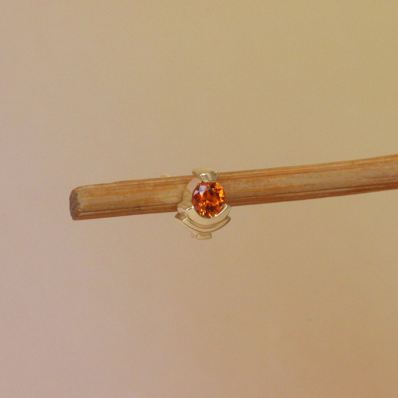 Lifestyle angled view of Step Mazunte Earring / Garnet by Goldpoint Jewelry on a wooden earring stand