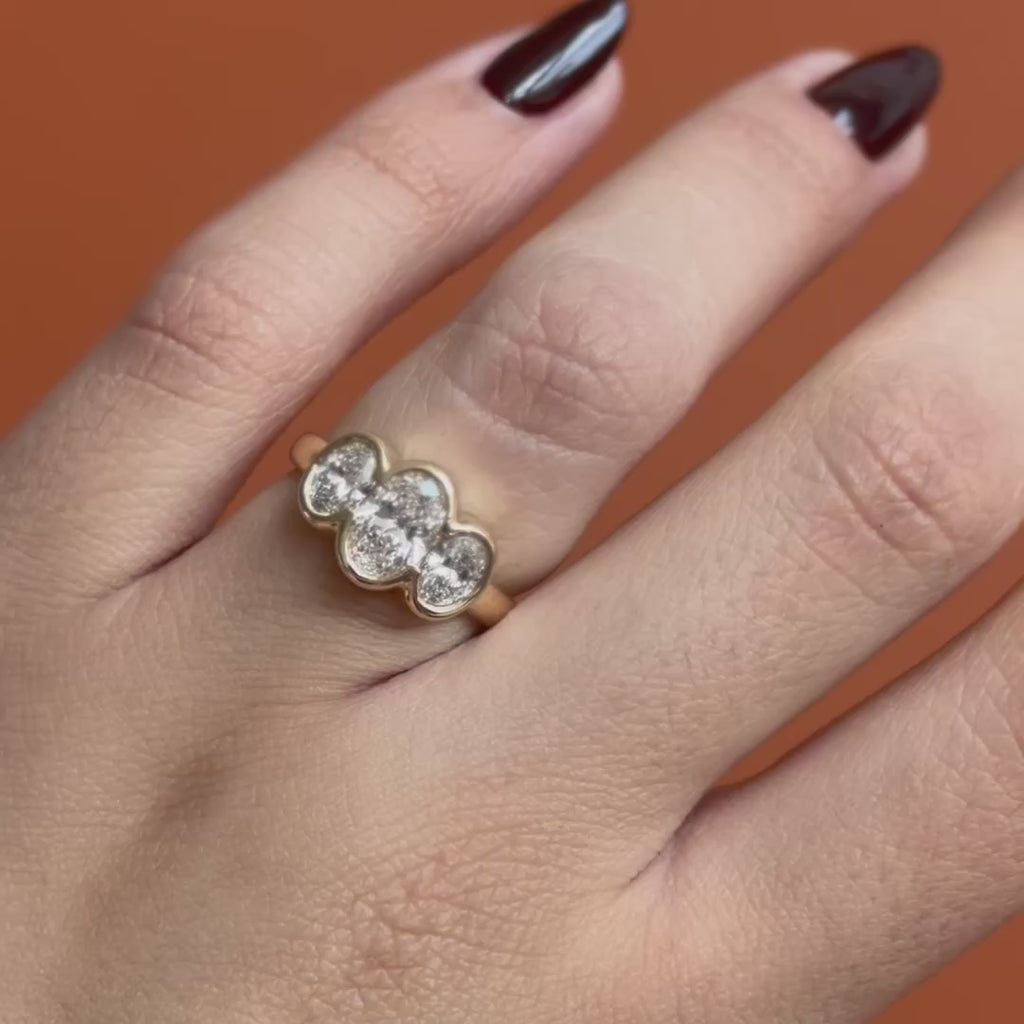 Model wears Clay 3 Ring Oval Lab Diamond 1.04ct by Goldpoint Jewelry while showing different angles over an orange backdrop
