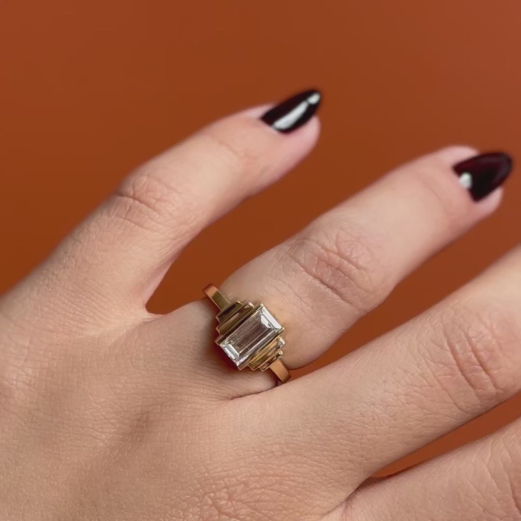 Model wears Kent Ring Baguette Lab Diamond 1.2ct by Goldpoint Jewelry on ring finger showing different angles on an orange backdrop