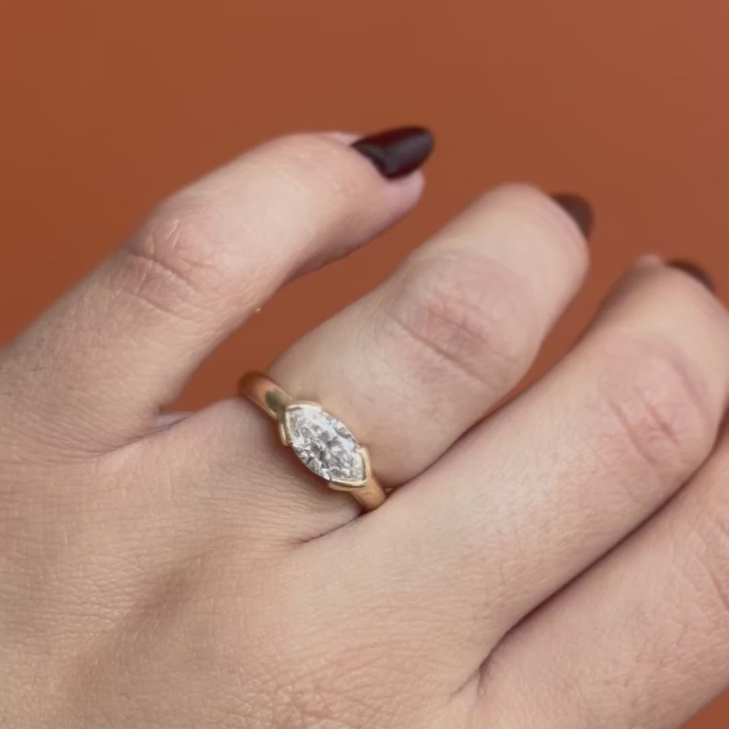Model wears Dobbin Ring Marquise Lab Diamond 1.04ct by Goldpoint Jewelry on ring finger showing different angles over an orange backdrop