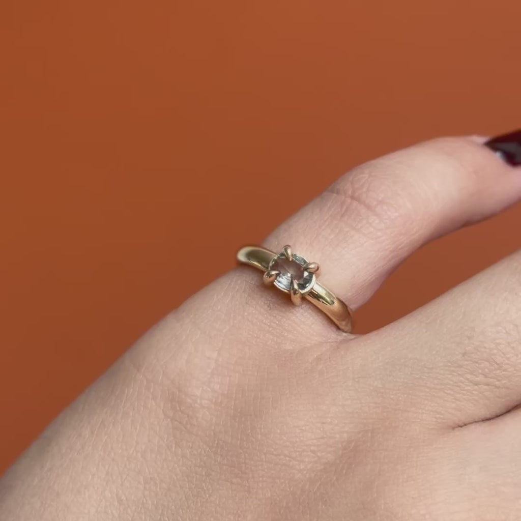 Model wears Sutton Ring Oval Sapphire 0.7ct by Goldpoint Jewelry on the pinky showing different angles over an orange backdrop
