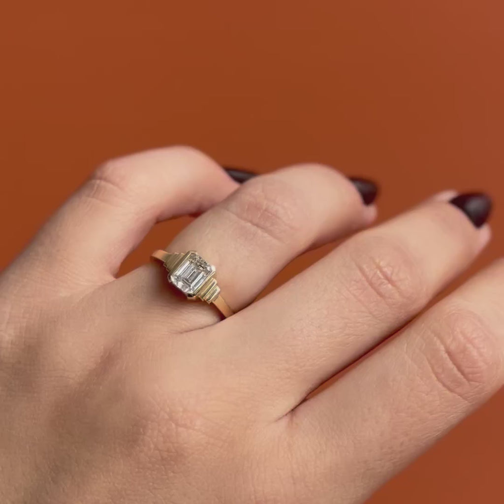 Model wears Kent Ring Emerald Cut Natural Diamond 1.1ct by Goldpoint Jewelry on ring finger showing different angles over an orange backdrop