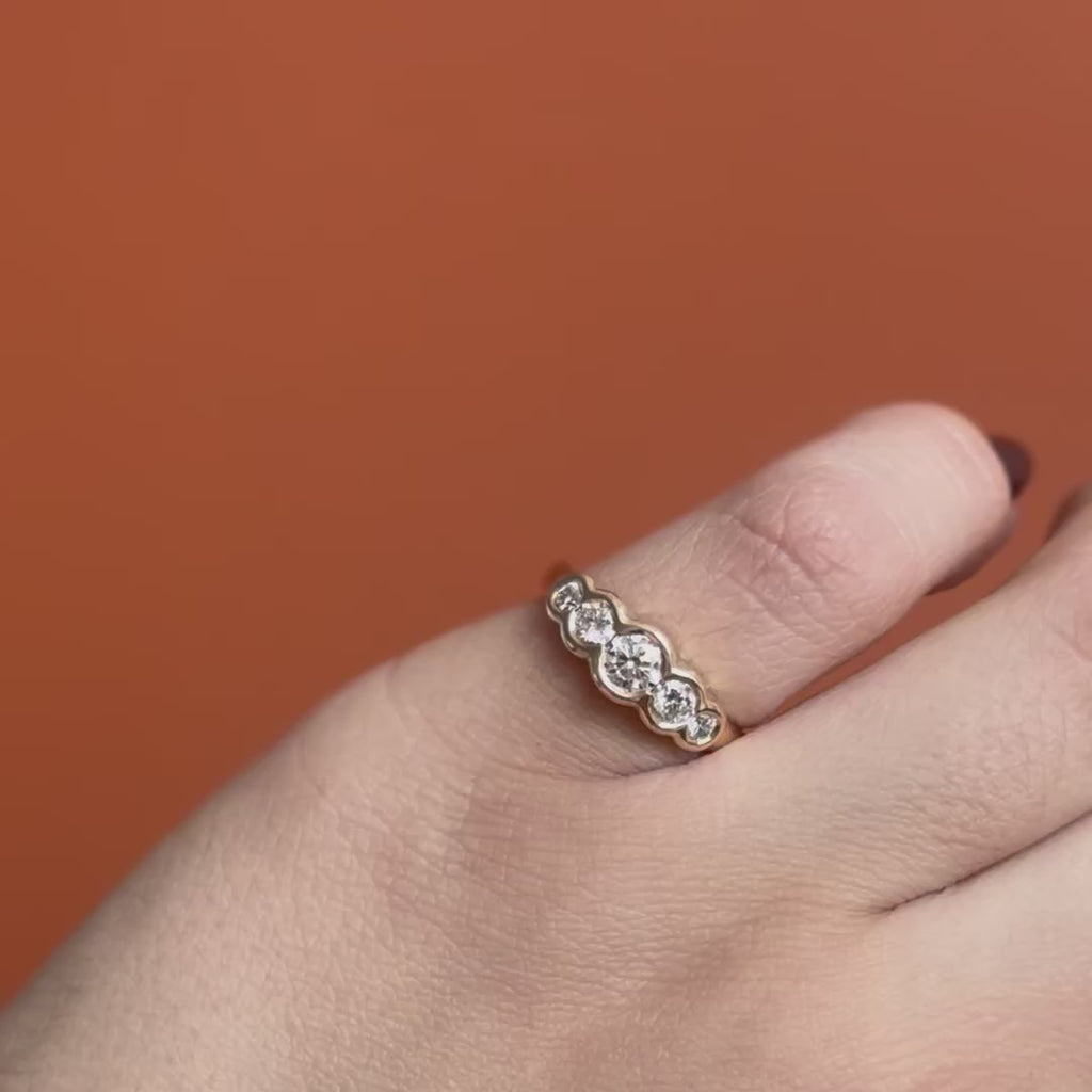 Model wears Clay 5 Ring Round Natural Diamond 0.35ct by Goldpoint Jewelry on pinky while showing different angles over an orange backdrop