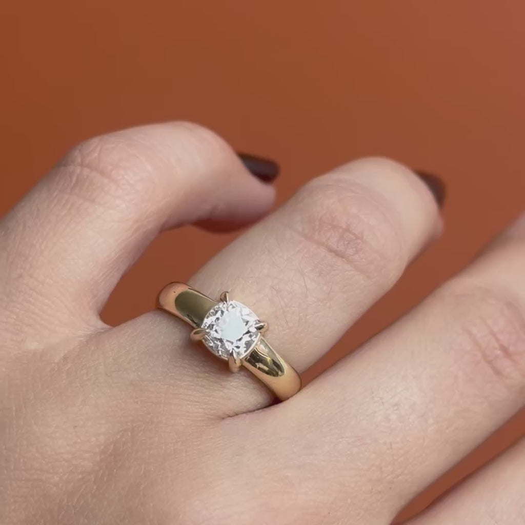 Model wears Sutton Ring Old Mine Natural Diamond 1.32ct by Goldpoint Jewelry on a ring finger showing different angles over an orange backdrop