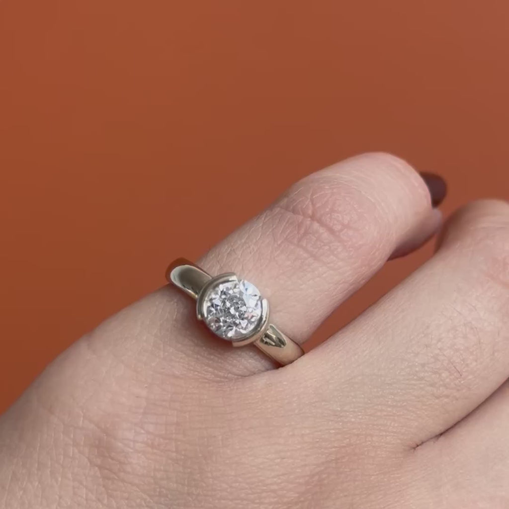 Model wears the Dobbin Ring Old Euro Lab Diamond 1.53ct by Goldpoint Jewelry on pinky finger showing different anglges on an orange backdrop