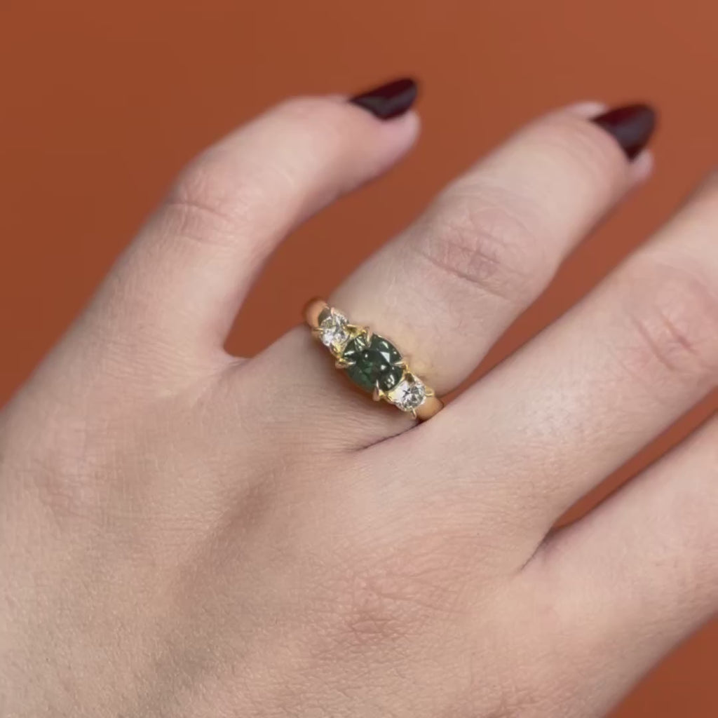 Model wears Sutton 3 Ring Oval Sapphire 1.63ct by Goldpoint Jewelry on the ring finger showing different angles over an orange backdrop
