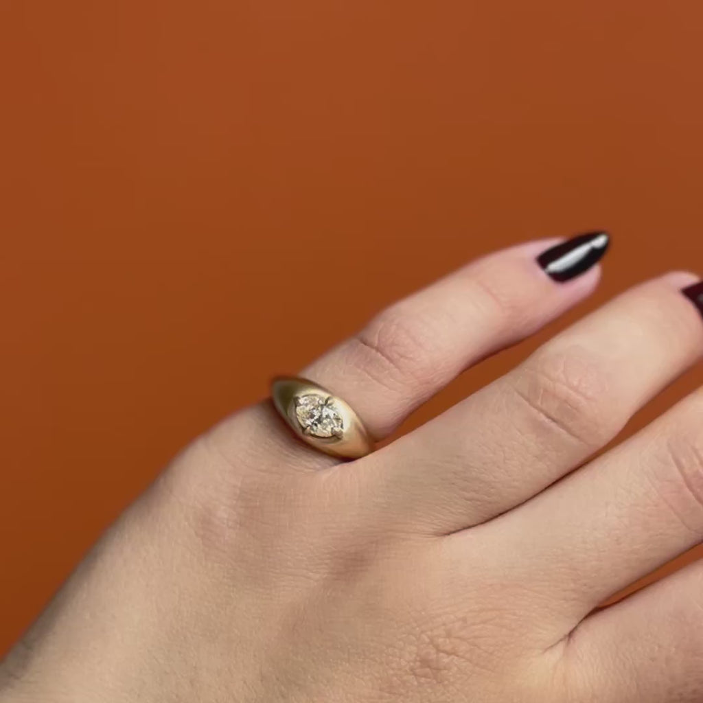 Model wears Leonard 4 Ring Oval Natural Diamond 1.05ct by Goldpoint Jewelry on pinky finger showing different angles over an orange backdrop
