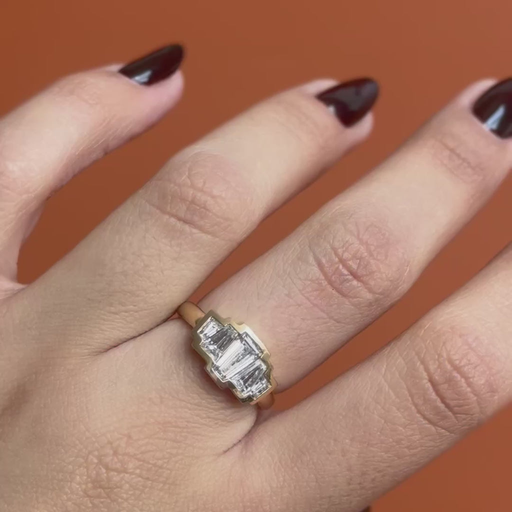 Model wears Clay 5 Ring Baguette Lab Grown Diamond 0.8ct by Goldpoint Jewelry on middle finger while showing different angles over an orange backdrop