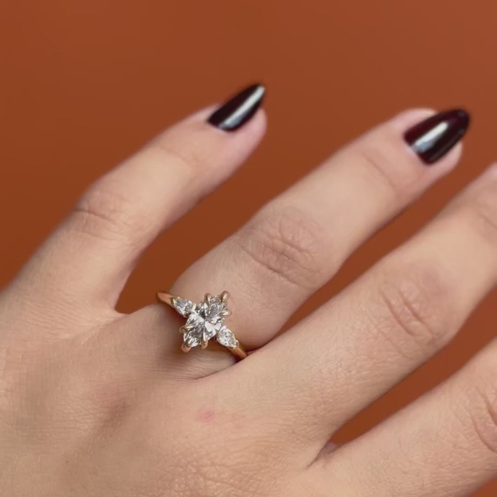 Model wears Wythe Ring Marquise Lab Diamond 1.04ct by Goldpoint Jewelry on ring finger showing different angles over an orange backdrop