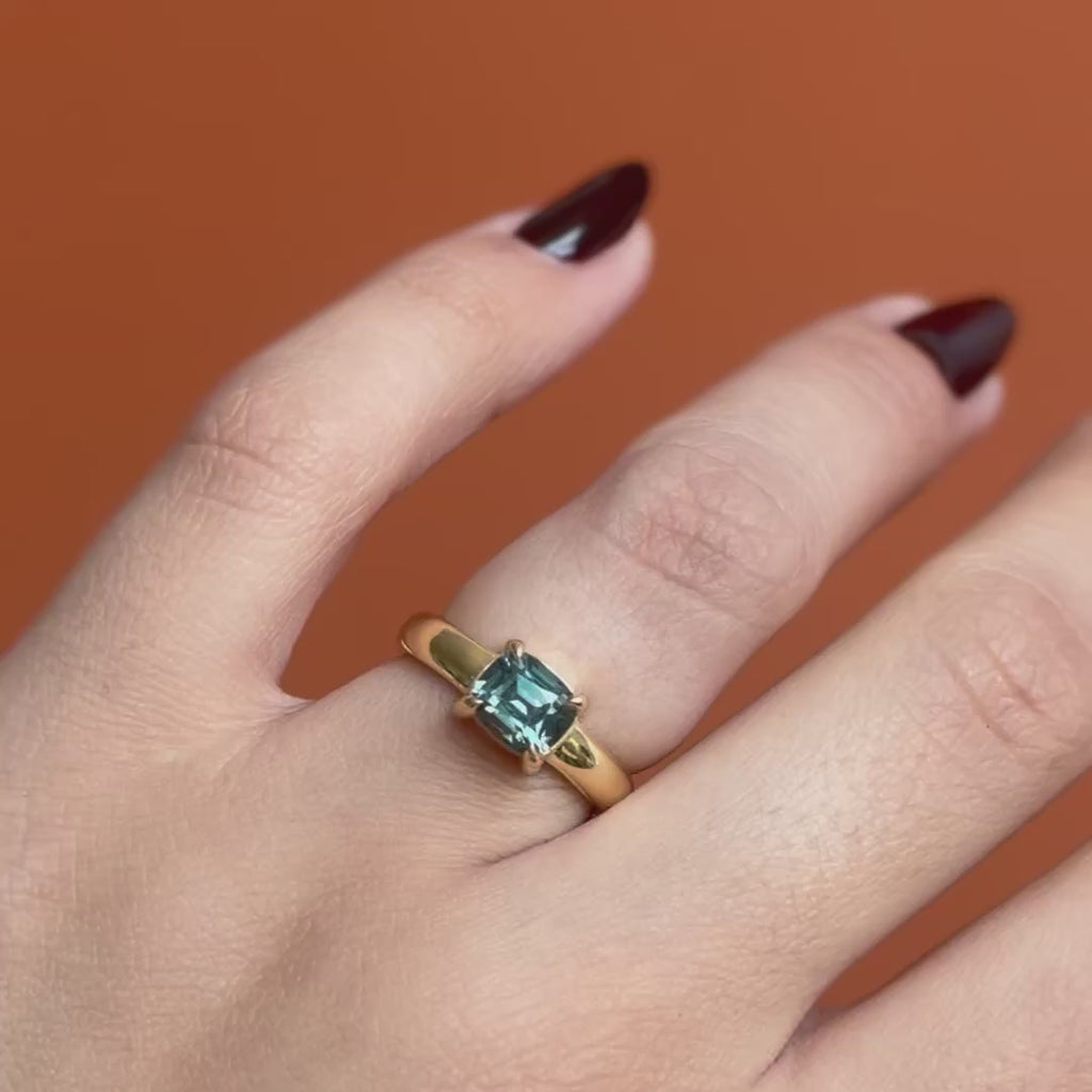 Model wears Sutton Ring Cushion Cut Sapphire 2.03ct by Goldpoint Jewelry on ring finger showing different angles on an orange backdrop