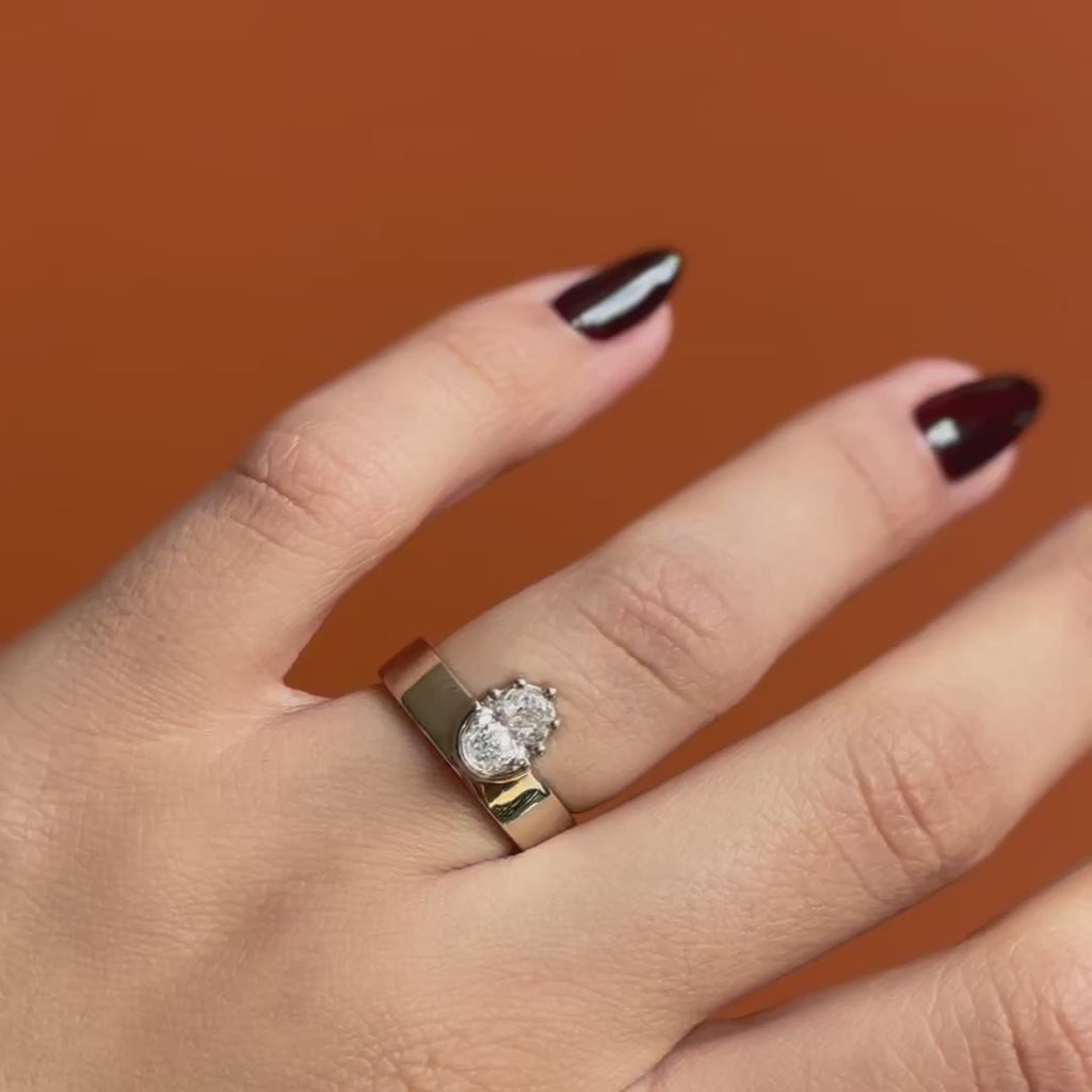 Model wears Varick Ring Oval Lab Diamond 1.03ct by Goldpoint Jewelry on the ring finger showing different angles over an orange backdrop