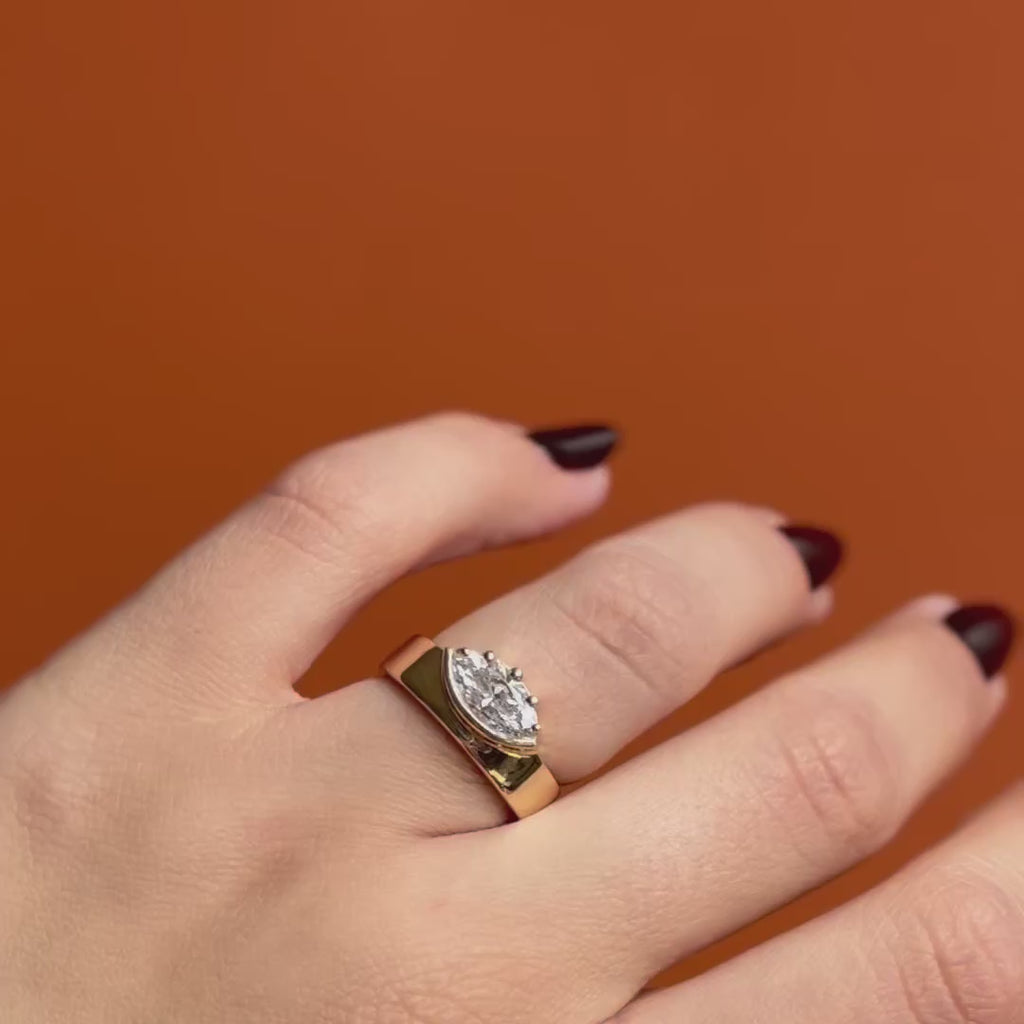 Model wears Varick Ring Marquise Lab Diamond 1.27ct by Goldpoint Jewelry on the ring finger over an orange backdrop