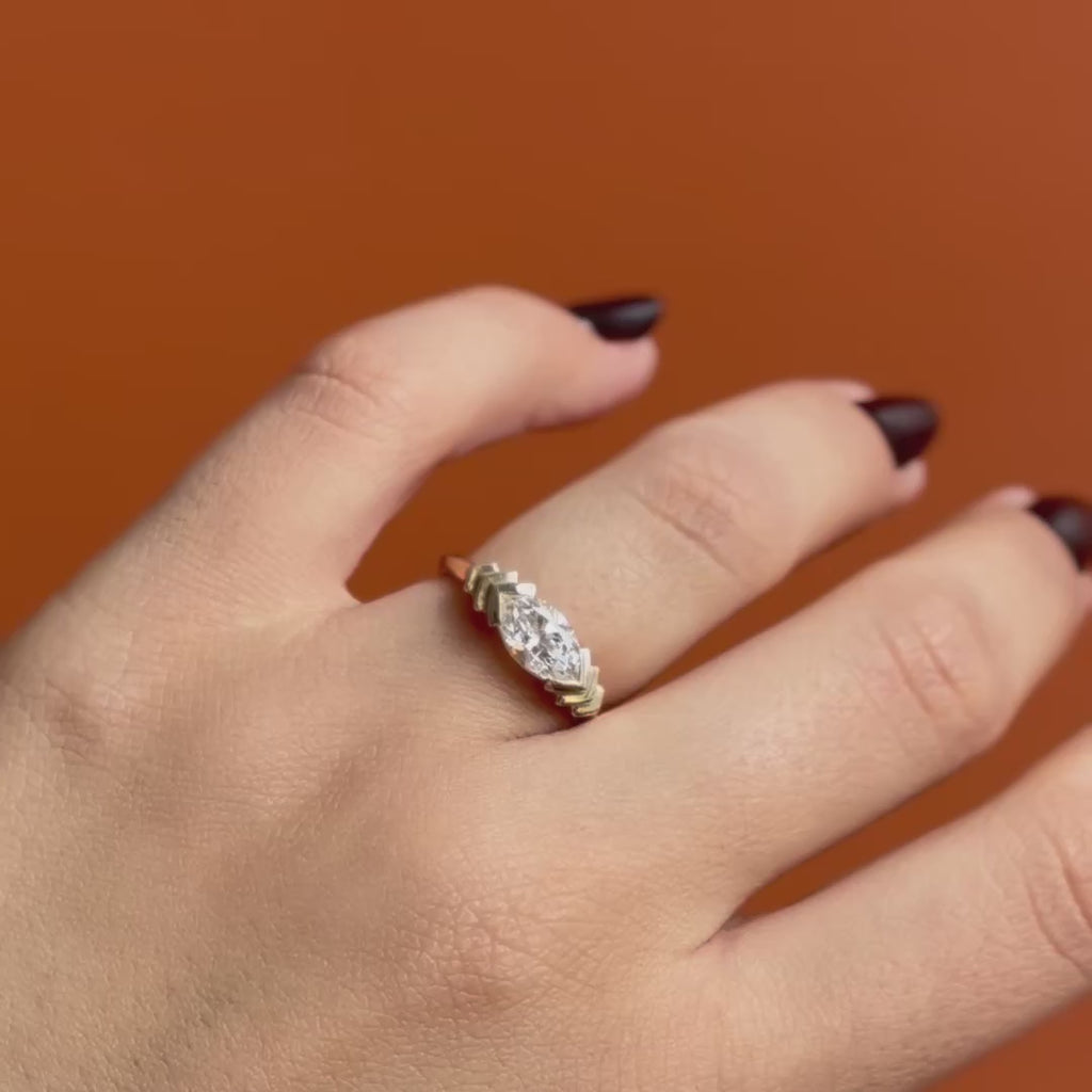 Model wears Kent Ring Marquise Lab Diamond 1.05ct by Goldpoint Jewelry on ring finger showing different angles over an orange backdrop