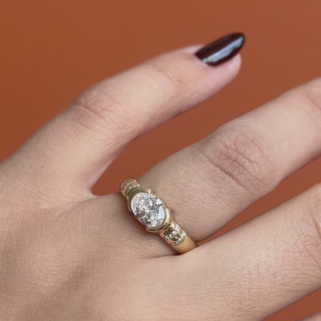 Model wears Dobbins Ring Oval Lab Diamond 1.01ct by Goldpoint Jewelry on ring finger while showing different angles over an orange backdrop