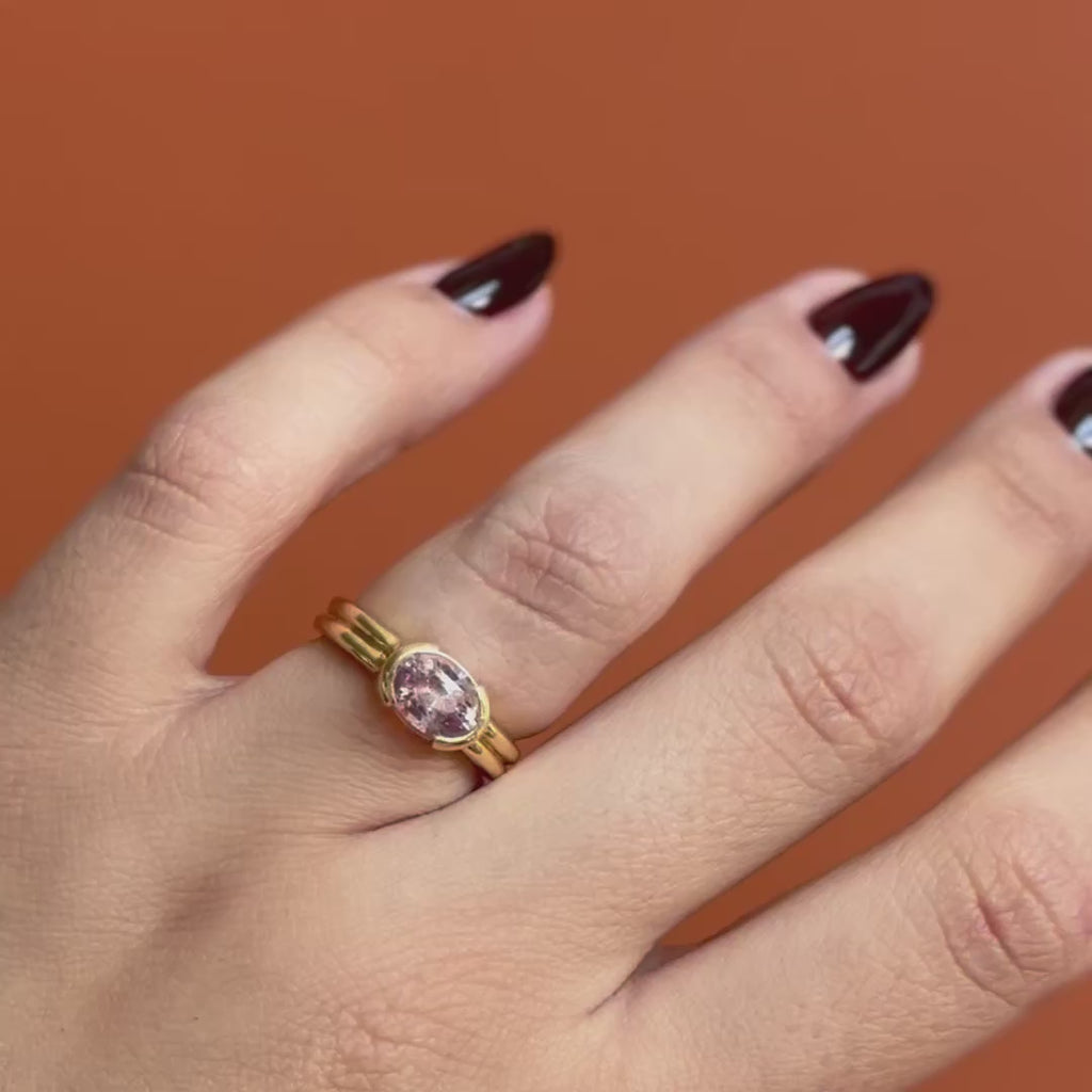Model wears the Franklin Ring Oval Sapphire 2.11ct by Goldpoint Jewelry on the ring finger while showing different views on an orange backdrop