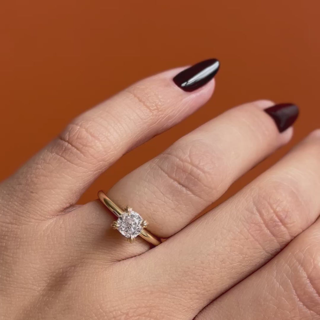 Model wears Calyer Ring Old Mine Natural Diamond 1.28ct by Goldpoint Jewelry on ring finger showing different angles over an orange backdrop