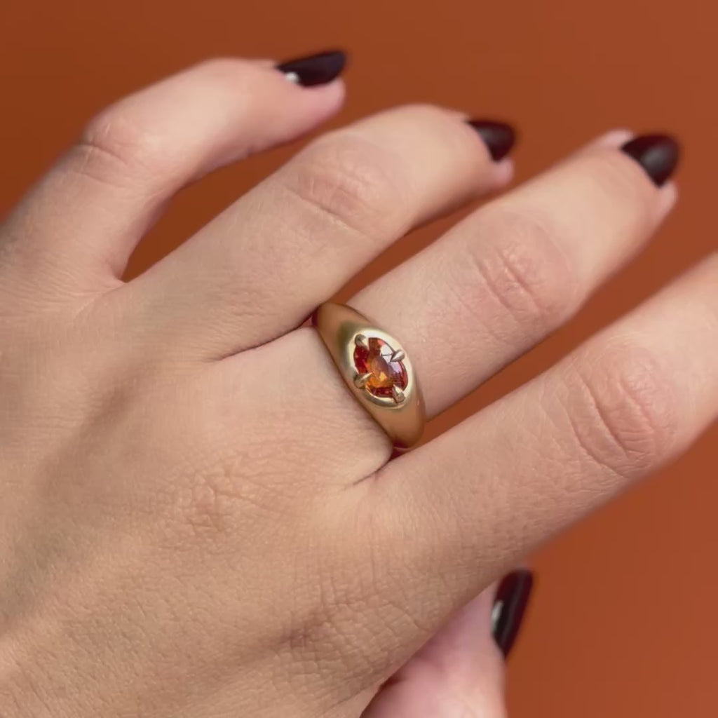Model wears Leonard 4 Ring Amorphous Rose Cut Sapphire 1.12ct by Goldpoint Jewelry on the middle finger showing different angles over an orange backdrop