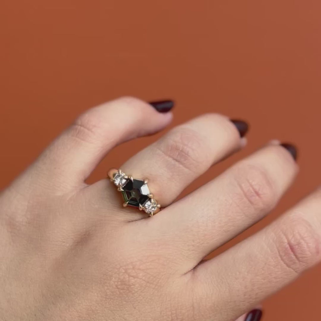 Model wears Sutton 3 Ring Hex Sapphire 1.74ct by Goldpoint Jewelry on ring finger showing different angles over an orange backdrop