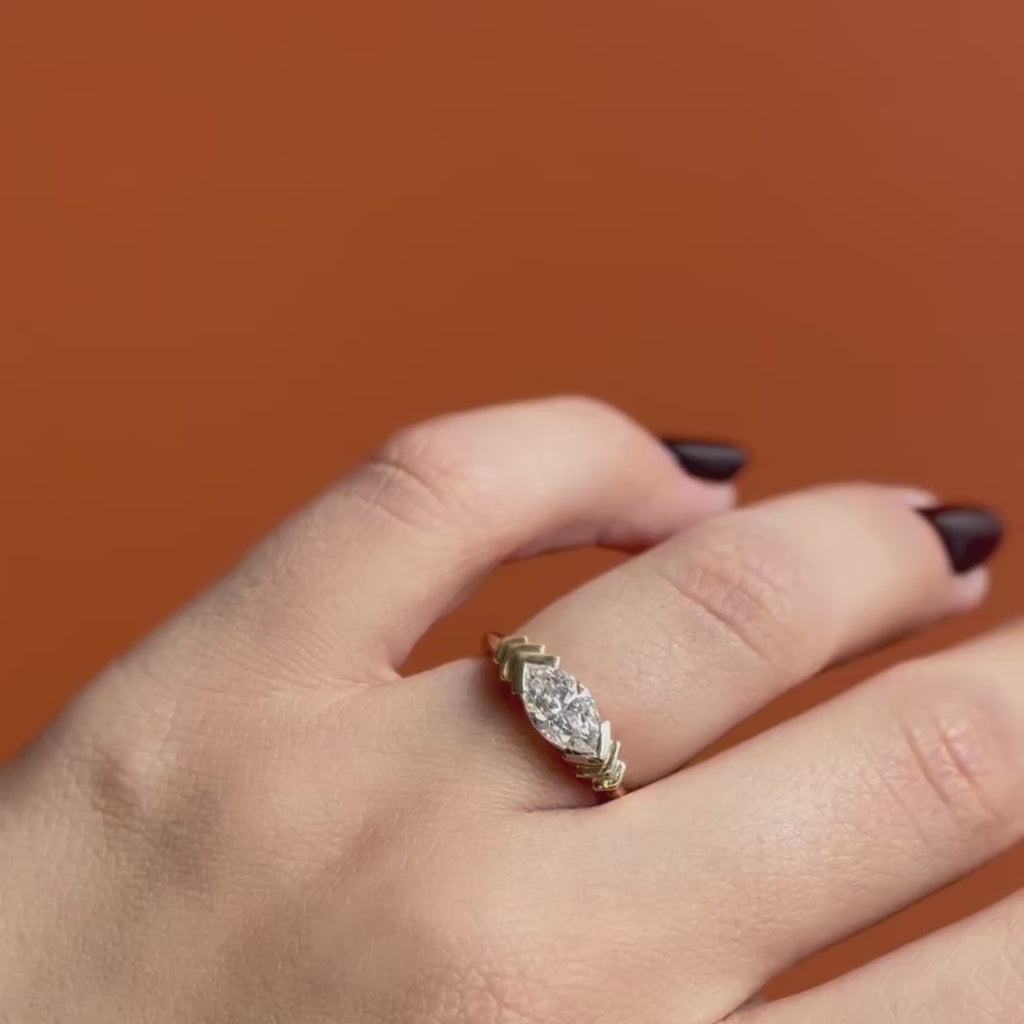 Model wears Kent Ring Marquise Lab Diamond 1.02ct by Goldpoint Jewelry on ring finger showing different angles over an orange backdrop