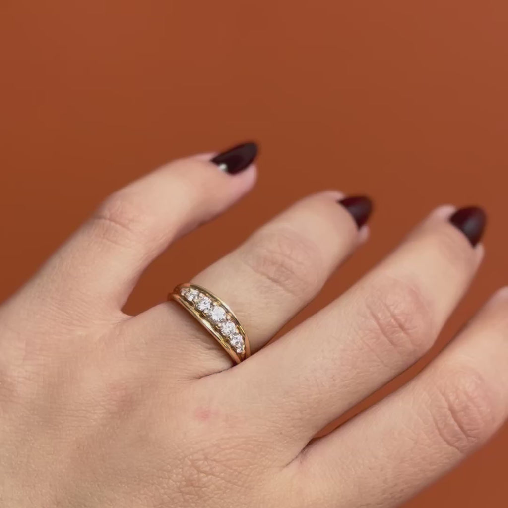 Model wears Humboldt Ring Round Natural Diamond 0.16ct by Goldpoint Jewelry on ring finger showing different angles over an orange backdrop