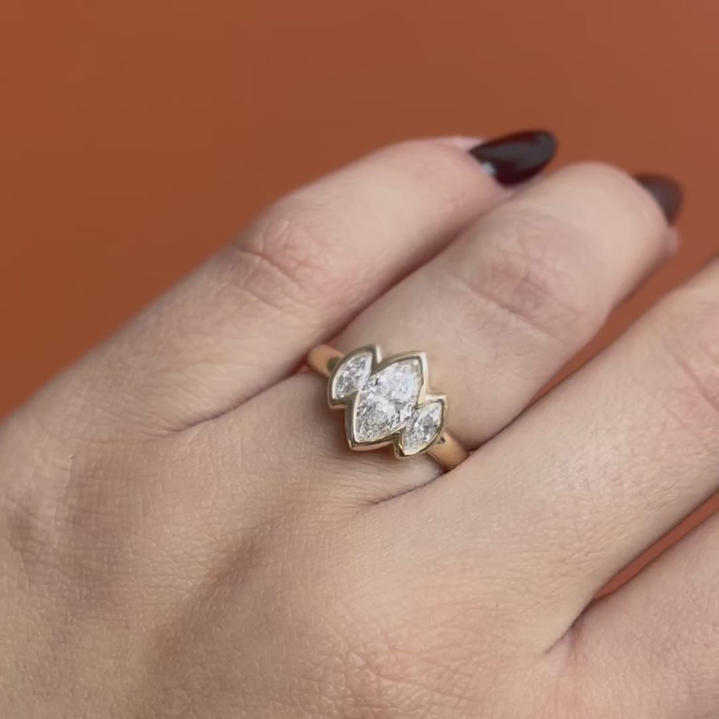 Model wears Clay 3 Ring Marquise Lab Diamond 1.02ct by Goldpoint Jewelry while showing different angles over an orange backdrop